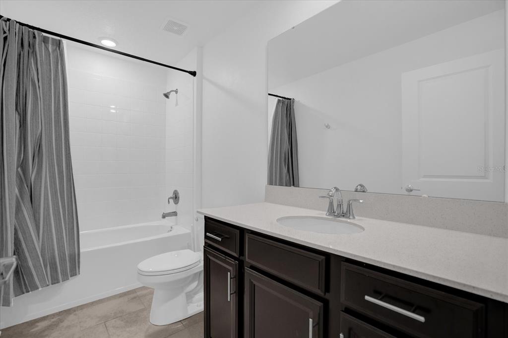 4712 Magnetite Loop Mount Mount Dora, FL 32757 - Photo 11 of 15 a bathroom with a sink a toilet and shower