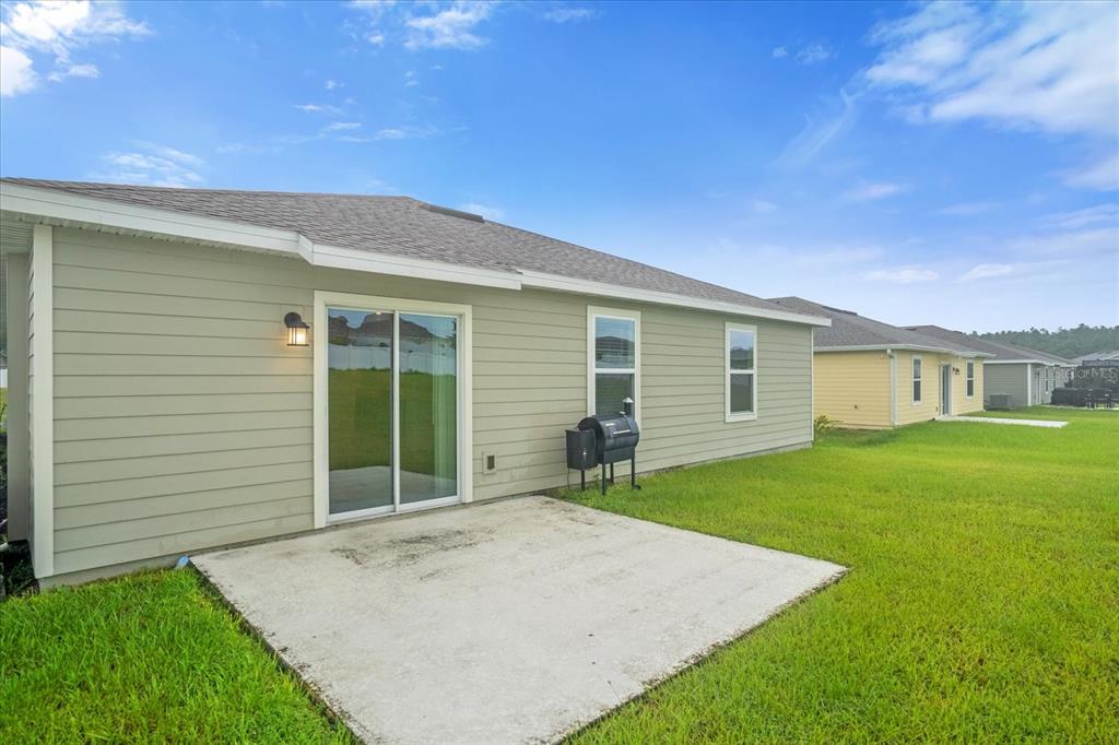 4712 Magnetite Loop Mount Mount Dora, FL 32757 - Photo 12 of 15 a view of a house with a backyard