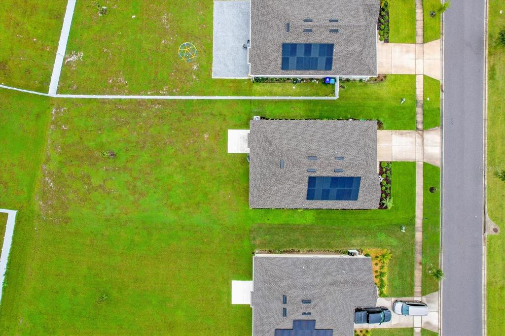 4712 Magnetite Loop Mount Mount Dora, FL 32757 - Photo 13 of 15 an aerial view of a house with a backyard