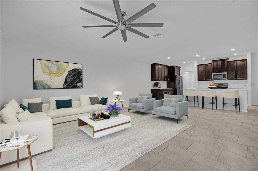 4712 Magnetite Loop Mount Mount Dora, FL 32757 - Photo 3 of 15 a living room with furniture and kitchen view