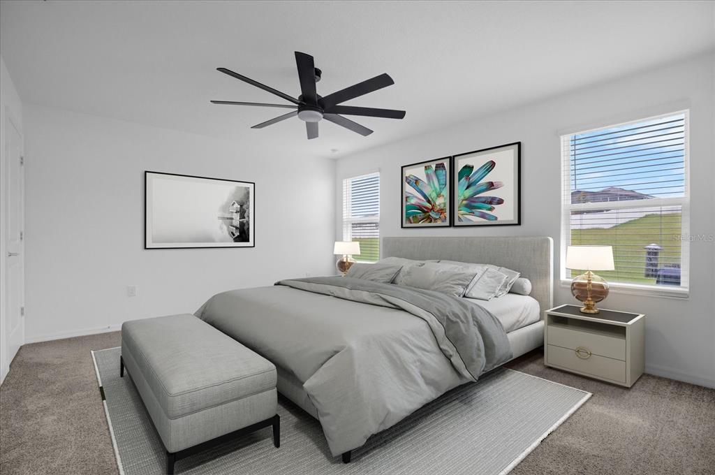 4712 Magnetite Loop Mount Mount Dora, FL 32757 - Photo 6 of 15 a bedroom with a large bed and a couch