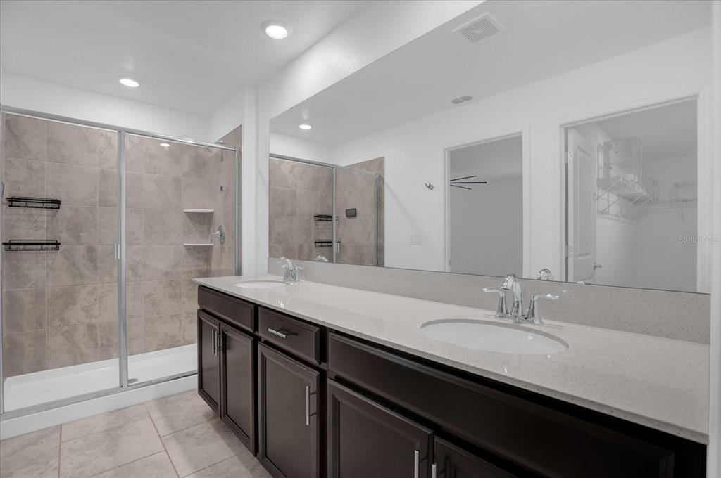 4712 Magnetite Loop Mount Mount Dora, FL 32757 - Photo 7 of 15 a bathroom with a granite countertop sink mirror and double