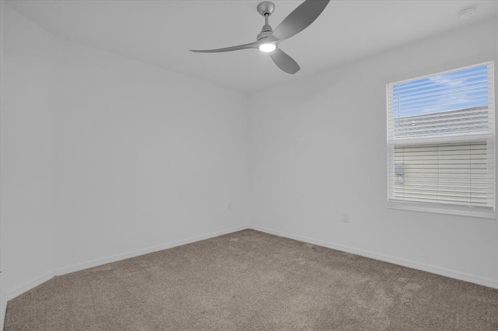 4712 Magnetite Loop Mount Mount Dora, FL 32757 - Photo 9 of 15 an empty room with a window