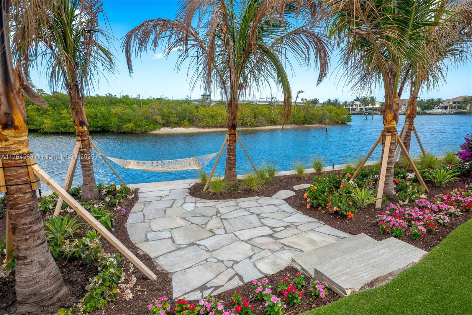 2455 Snook Trail Palm Beach Gardens, FL 33410 - Photo 1 of 64 a view of a garden with a table and chair