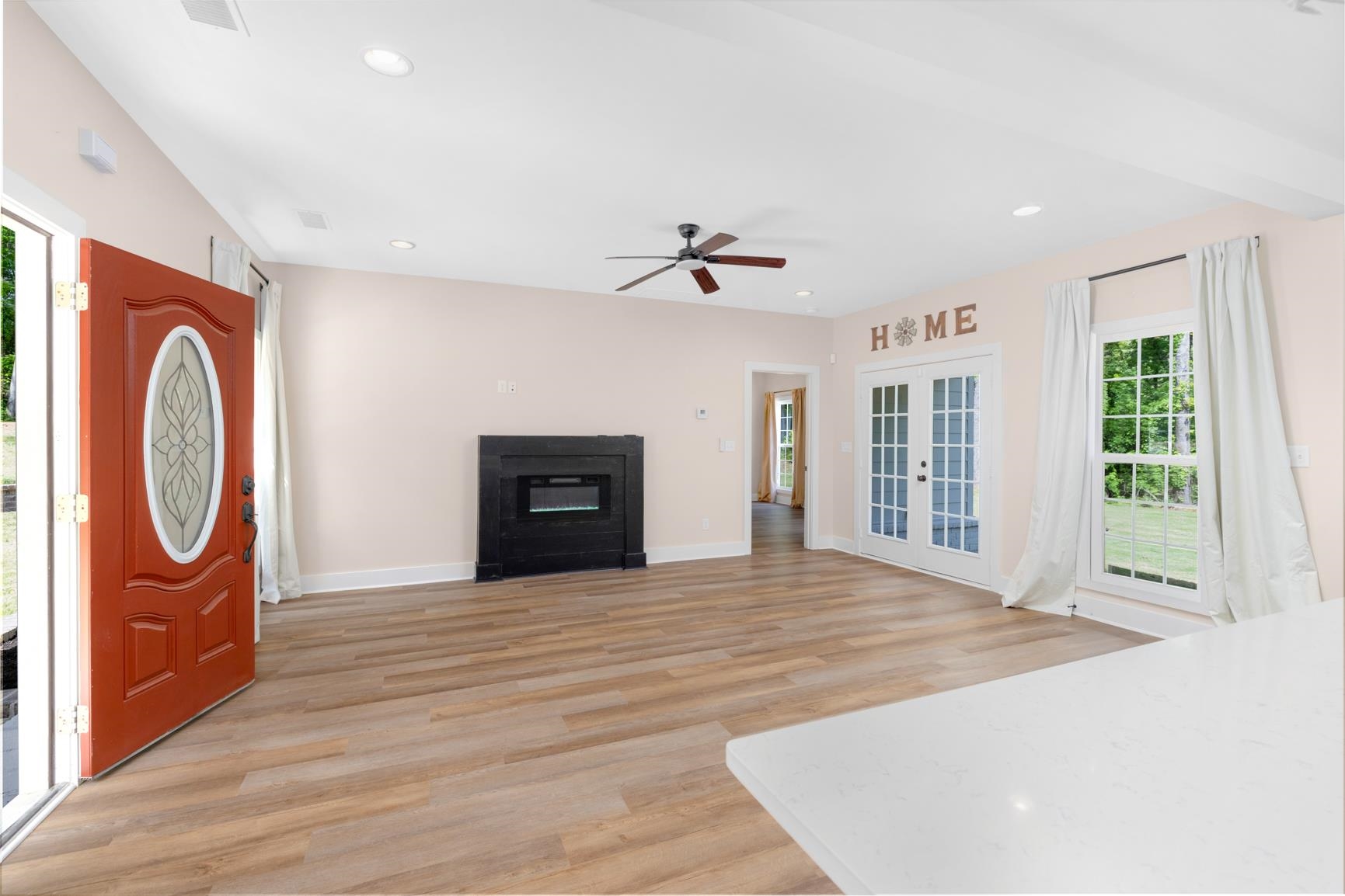 5702 Spring Lake Road Memphis, TN 38135 - Photo 6 of 40 Spacious living area featuring wood-finish flooring, recessed lighting, and a dark wood fireplace