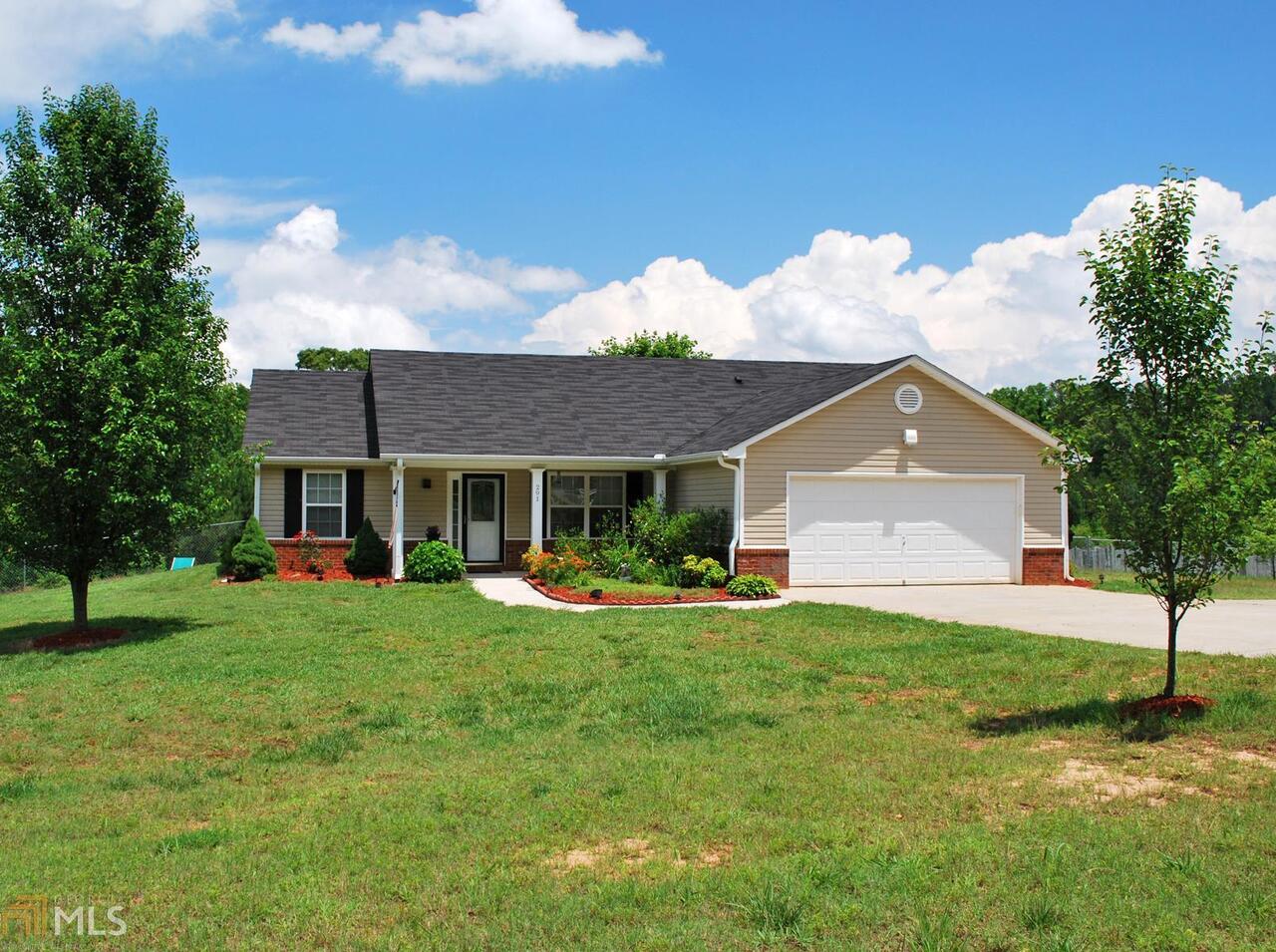 291 Jack Russell Road Newnan, GA 30263 - Photo 1 of 1 a front view of a house with a yard and trees