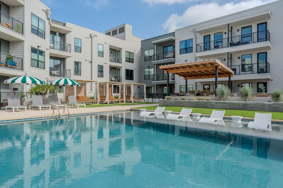 1701 Simond Avenue, Unit 201 Austin, TX 78723 - Photo 13 of 19 Resort style swimming pool with cabanas and seating areas