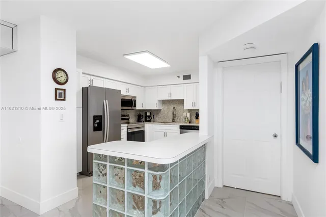 a kitchen with stainless steel appliances a refrigerator and a stove