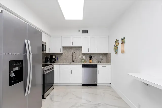 a kitchen with a refrigerator sink and white stove