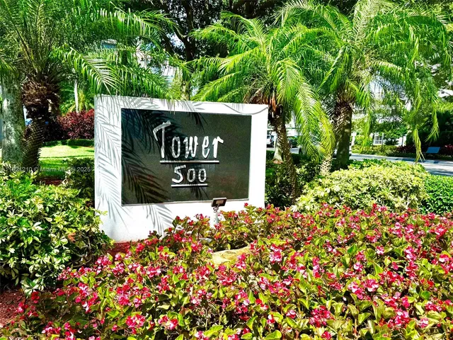 a sign that is sitting in front of flowers