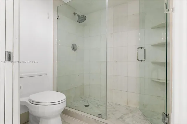 a bedroom with bed and a chandelier