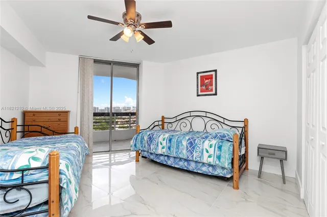a bedroom with a bed a couch and a chandelier