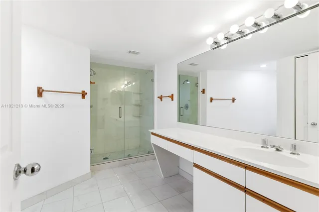 a spacious bathroom with a shower and a sink