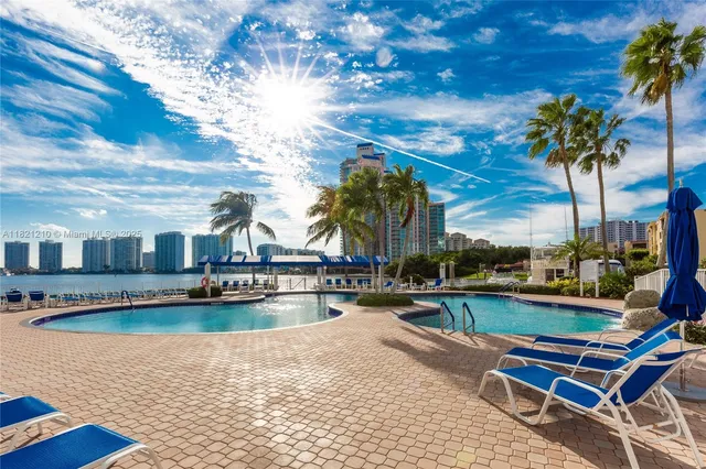 a view of swimming pool with outdoor seating and plants