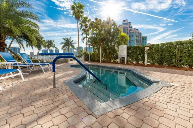 a view of a big yard with an ocean view