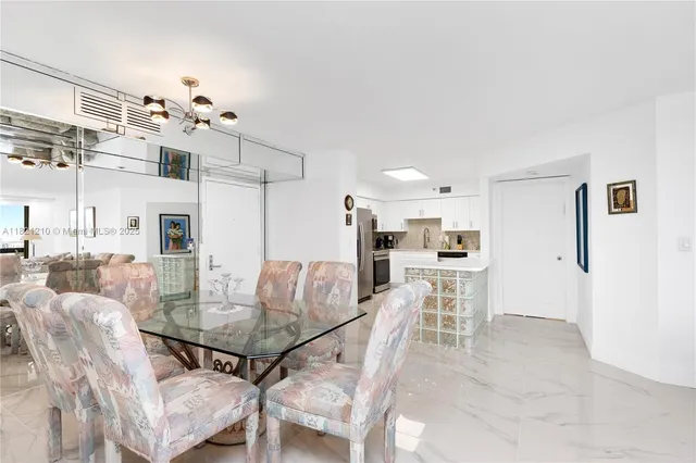 a view of a dining room with furniture and chandelier