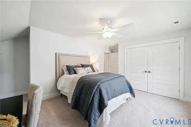 a bedroom with a bed and a ceiling fan