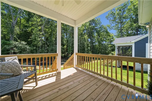 a view of balcony with wooden floor and fence
