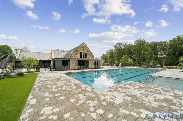a view of backyard with swimming pool and outdoor seating