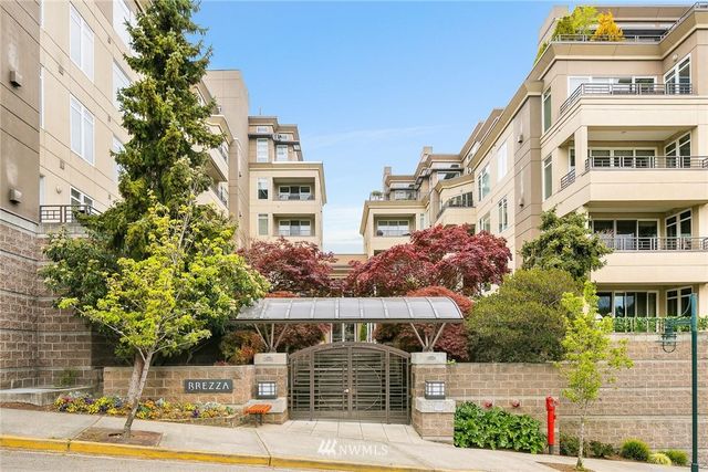 a front view of a multi story building with yard