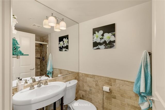 a bathroom with a sink mirror and vanity