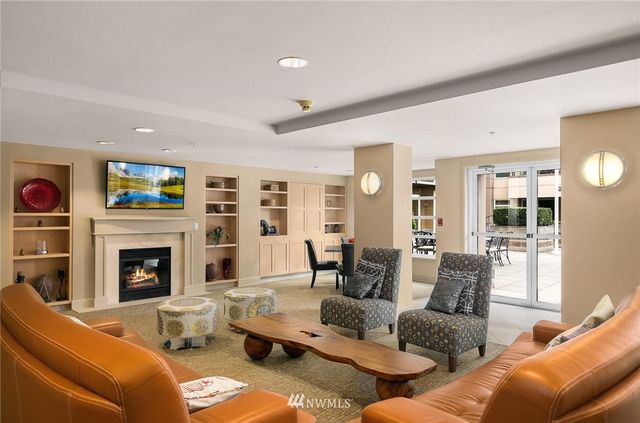 a living room with furniture fireplace and cabinet