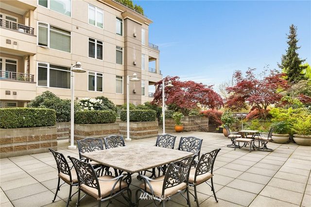 a view of a patio with table and chairs and potted plants