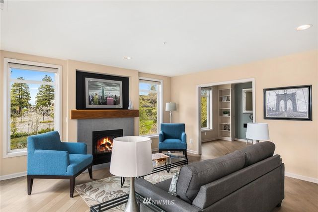 a living room with furniture a fireplace and a window