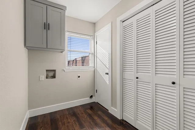 a view of a closet area with wooden floor