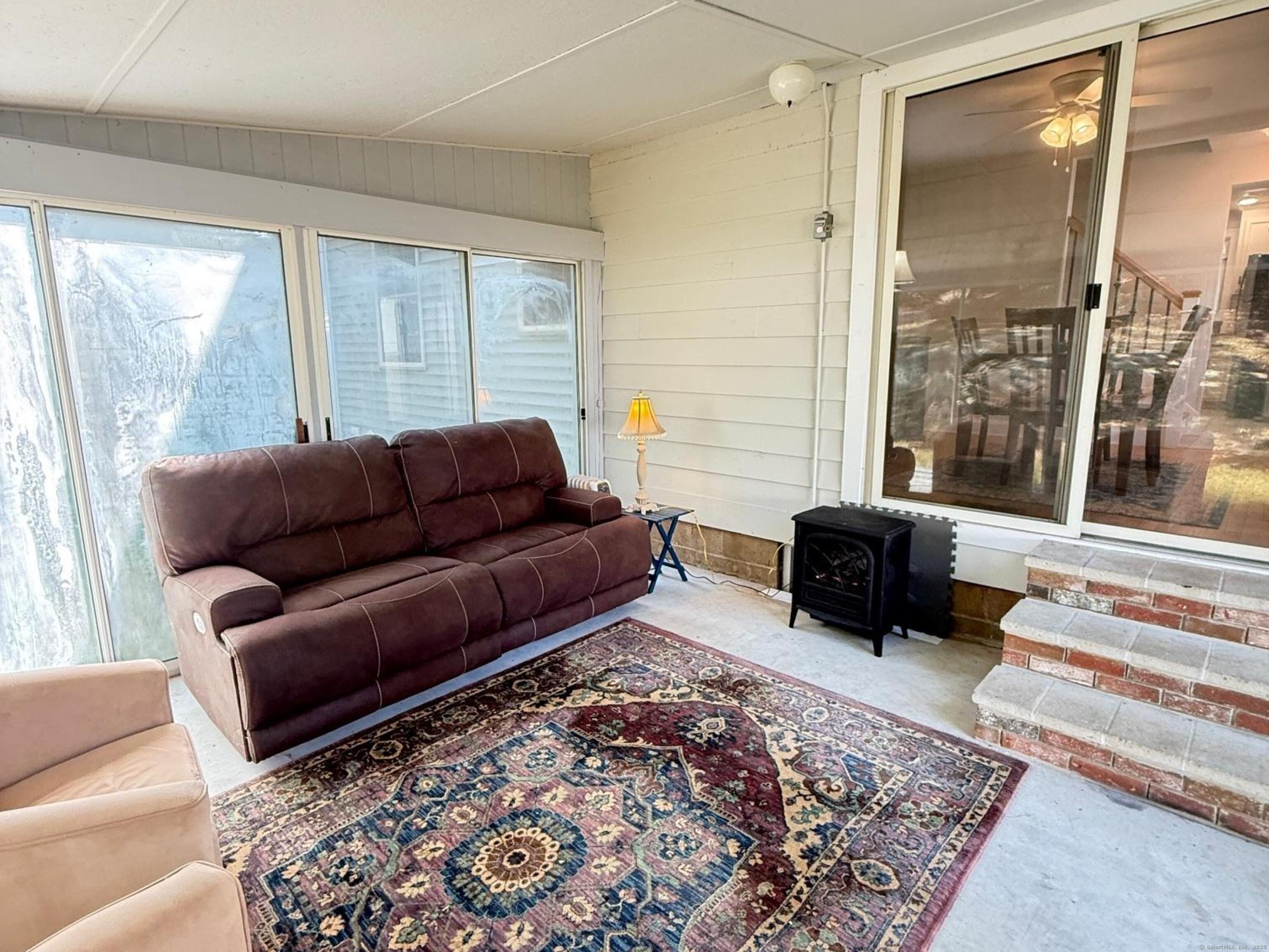 152 Hewitt Road Stonington, CT 06355 - Photo 14 of 34 a living room with furniture and a rug