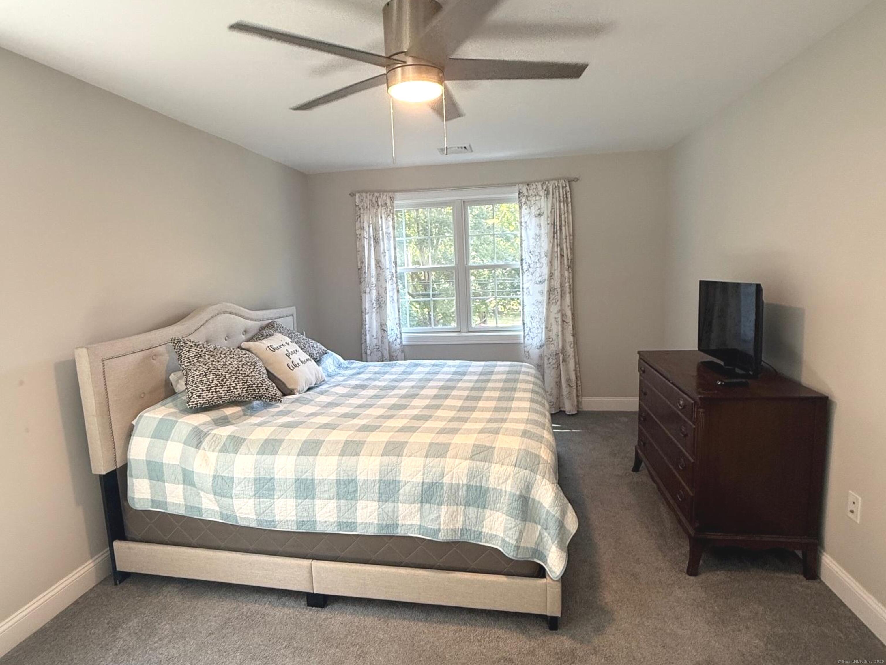 152 Hewitt Road Stonington, CT 06355 - Photo 20 of 34 a bedroom with a bed and a tv