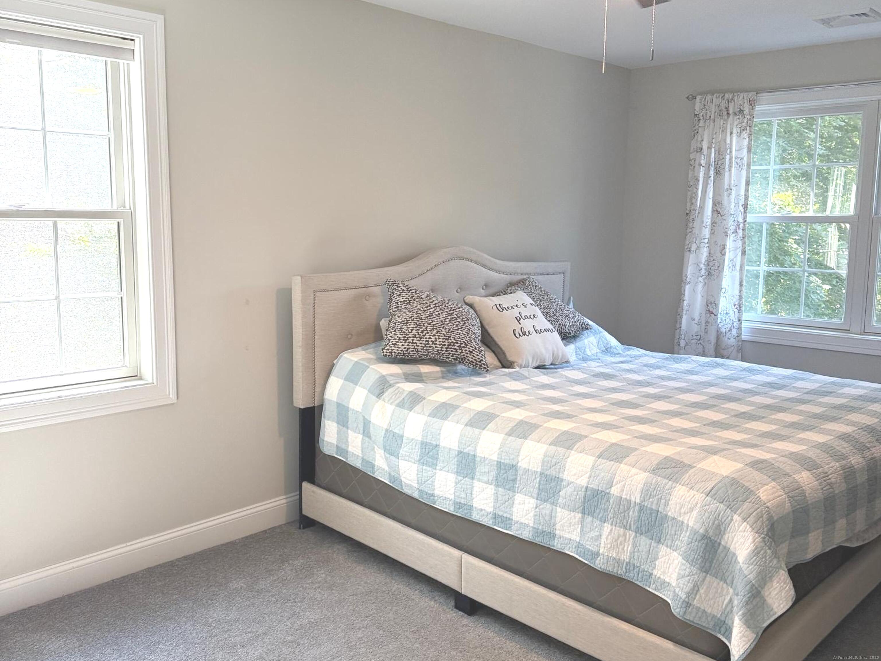 152 Hewitt Road Stonington, CT 06355 - Photo 23 of 34 a large bed sitting in a bedroom next to a window
