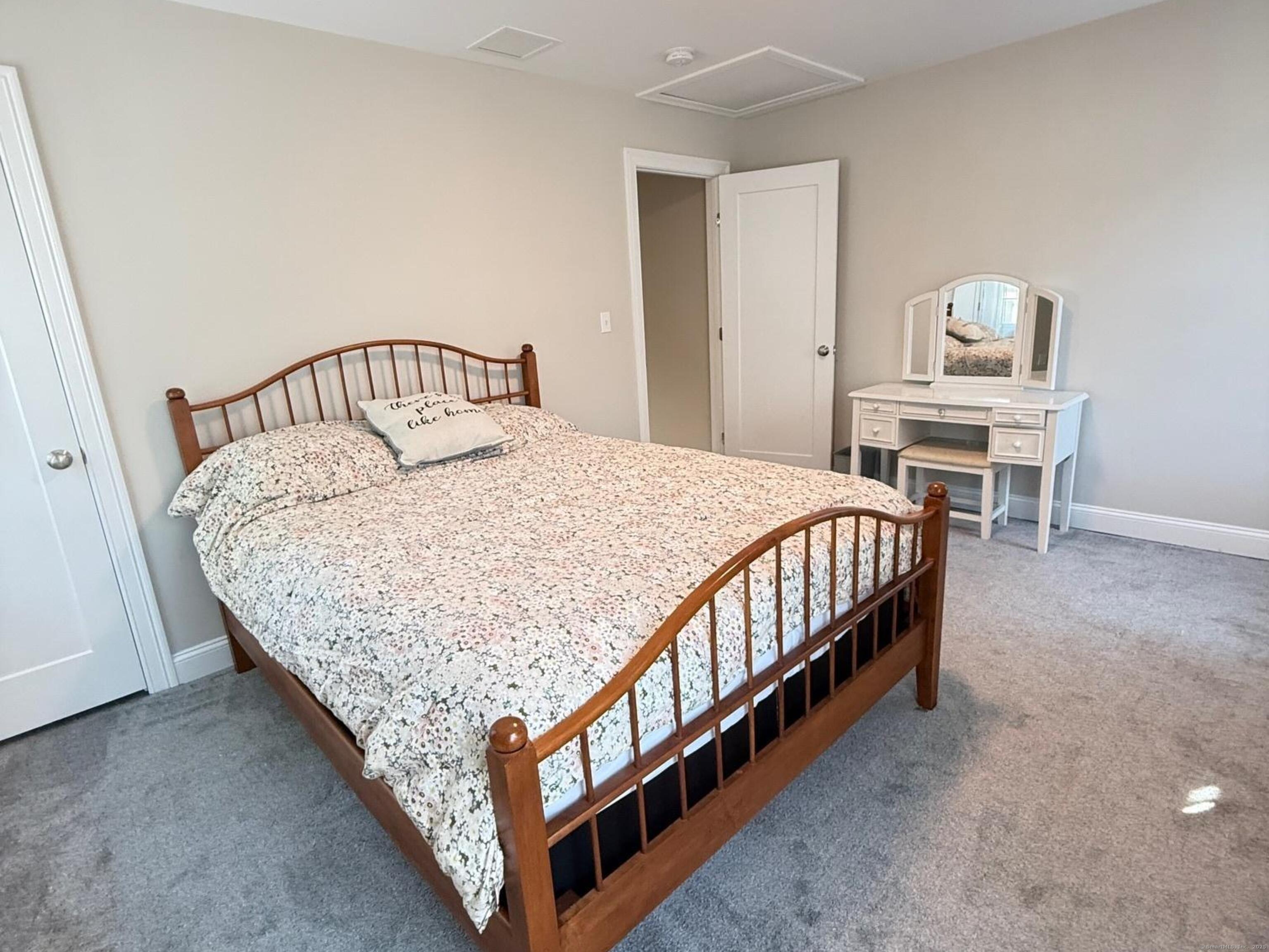 152 Hewitt Road Stonington, CT 06355 - Photo 27 of 34 a bed sitting in a bedroom next to a window