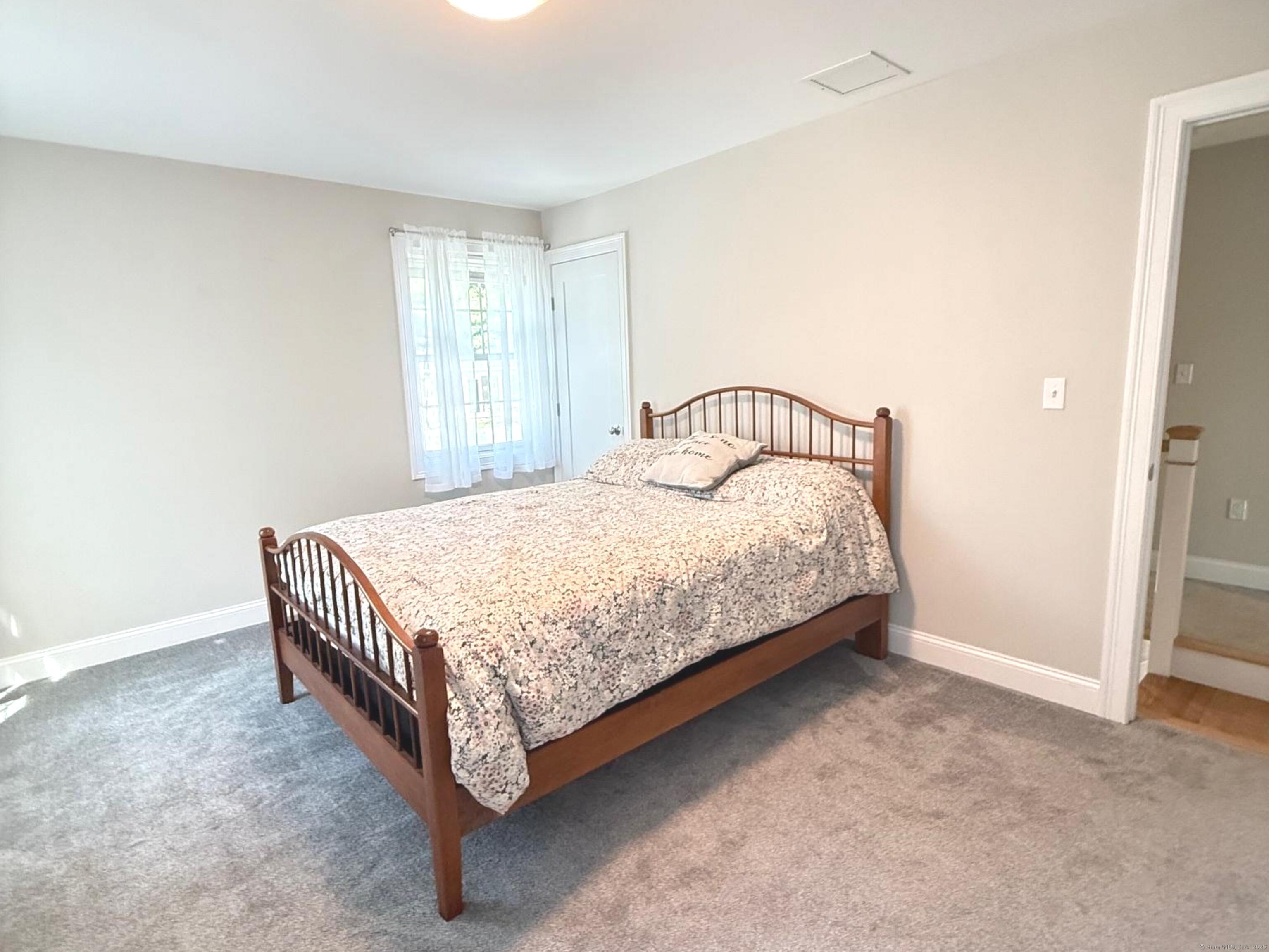 152 Hewitt Road Stonington, CT 06355 - Photo 28 of 34 a bedroom with a bed and a window