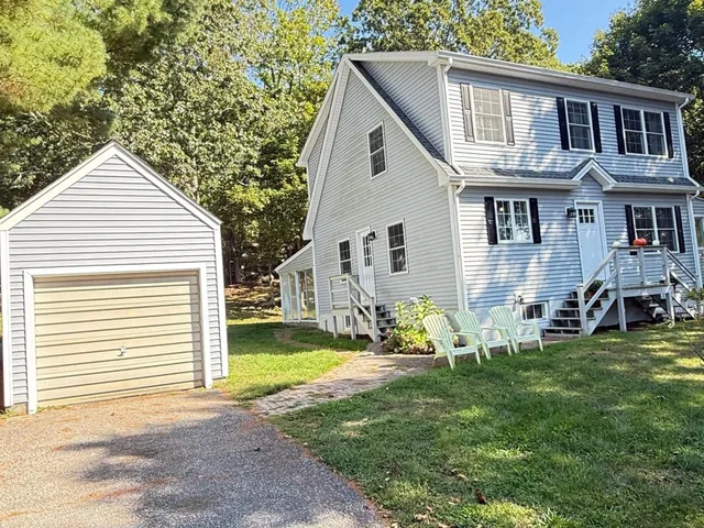 a view of a house with a yard and sitting area