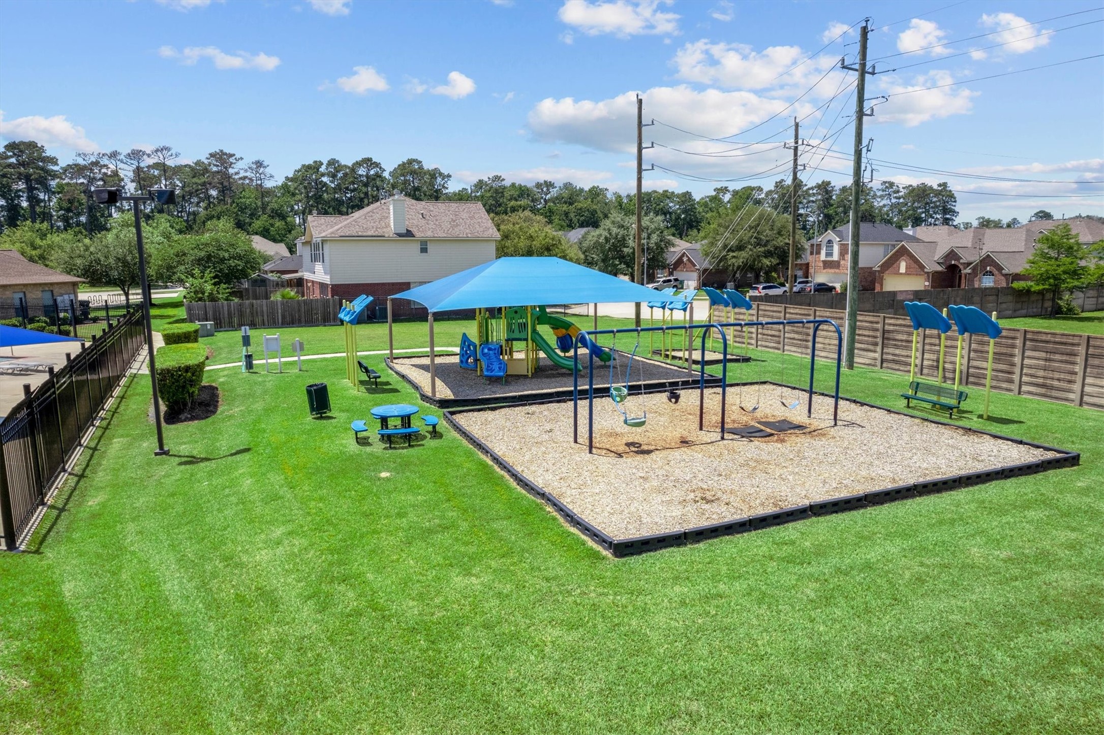2507 Grayfeather Court Spring, TX 77388 - Photo 36 of 37 Well-maintained community playground with swings, slides, and seating areas.