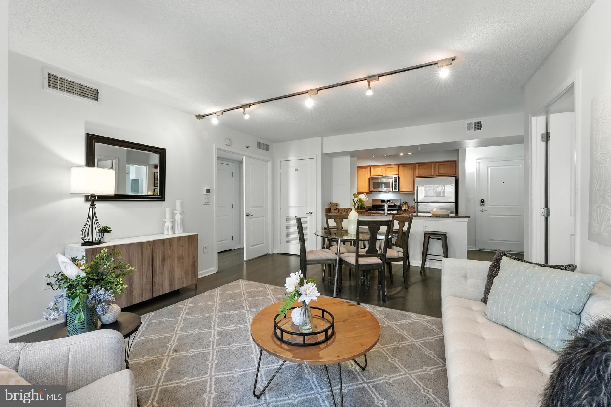 7923 Eastern Avenue Northwest, Unit 303 Silver Spring, MD 20910 - Photo 12 of 38 a living room with furniture and wooden floor