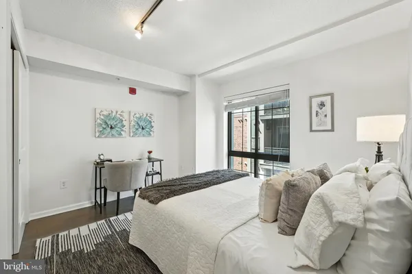 a bedroom with a bed and a lamp on table