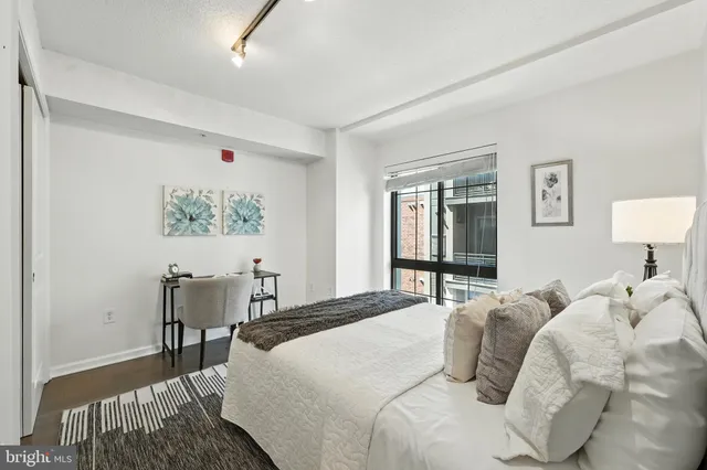 a bedroom with a bed and a lamp on table