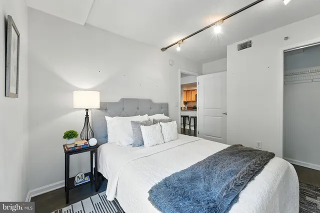 a bedroom with a bed and a lamp on table