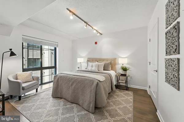 a spacious bedroom with a bed and a table in it