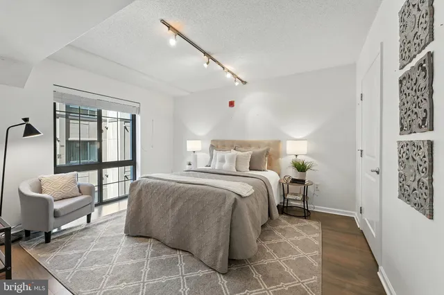 a spacious bedroom with a bed and a table in it