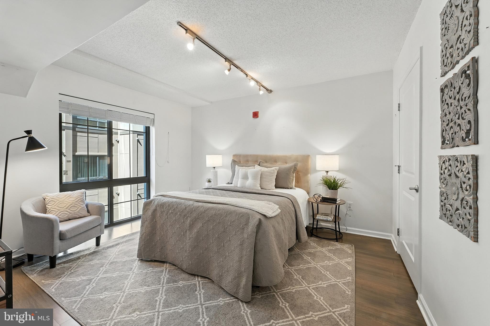 7923 Eastern Avenue Northwest, Unit 303 Silver Spring, MD 20910 - Photo 20 of 38 a bedroom with a bed and a couch