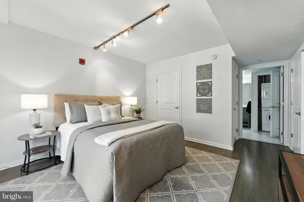 a bedroom with a bed and a large clock on the wall