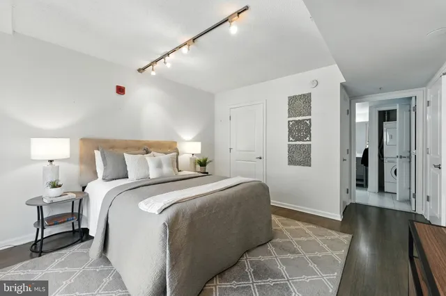 a bedroom with a bed and a large clock on the wall