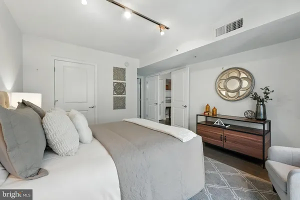 a bedroom with a bed and a large window