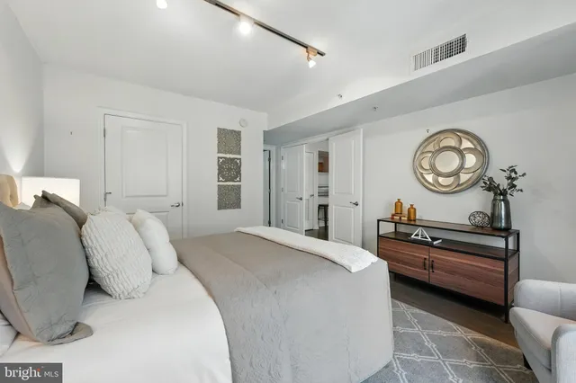 a bedroom with a bed and a large window