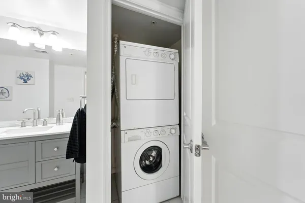 a spacious bathroom with a double vanity sink toilet mirror and shower