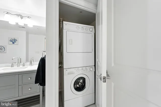 a spacious bathroom with a double vanity sink toilet mirror and shower