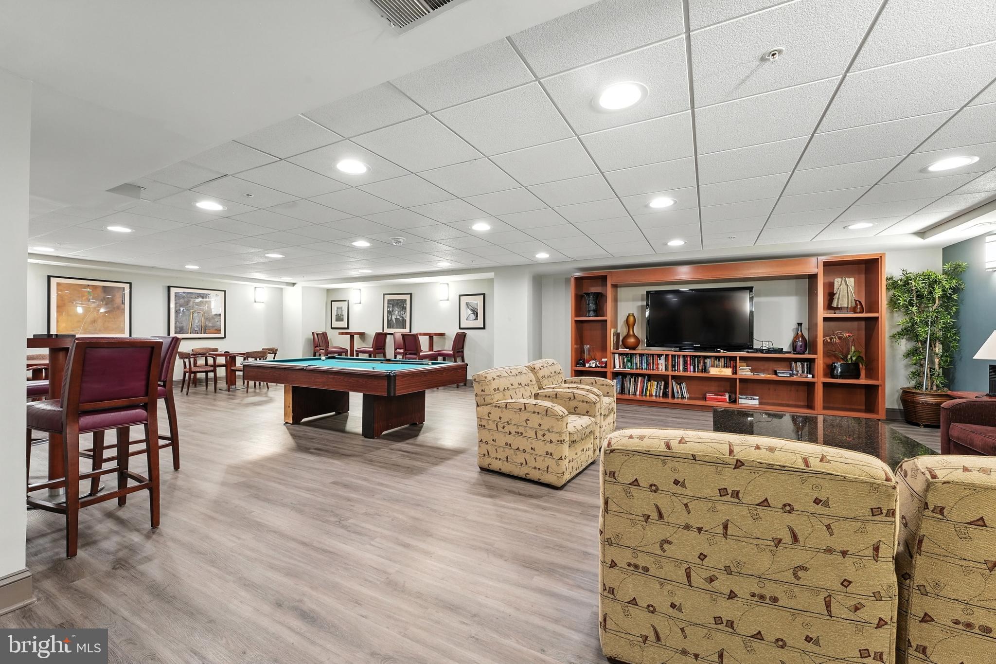 7923 Eastern Avenue Northwest, Unit 303 Silver Spring, MD 20910 - Photo 33 of 38 a living room with furniture and a flat screen tv